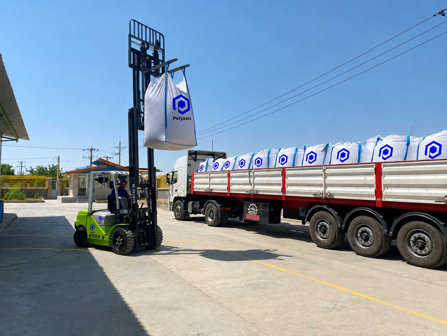 Forklift loading PolyAzin big-bags onto a flatbed truck at the plant gate